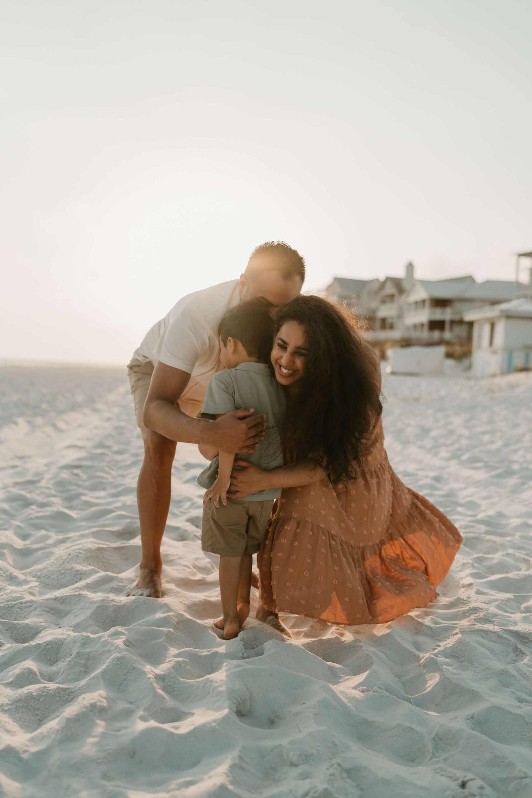 The Vargas family smile and play on the beach.