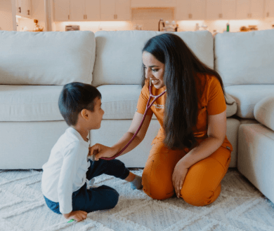 Dr. Vargas smiles as she checks the heartbeat of a child with a stethoscope. Contact today to learn more about Marigold Pediatrics!