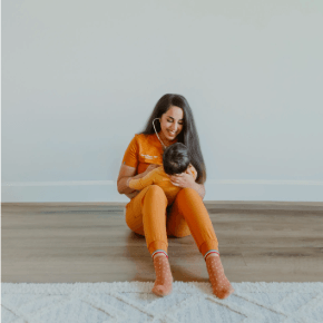 Dr. Vargas, Marigold Pediatrics founder, checks the heartbeat of a baby with a stethoscope while smiling. Contact today to learn more about Marigold Pediatrics.